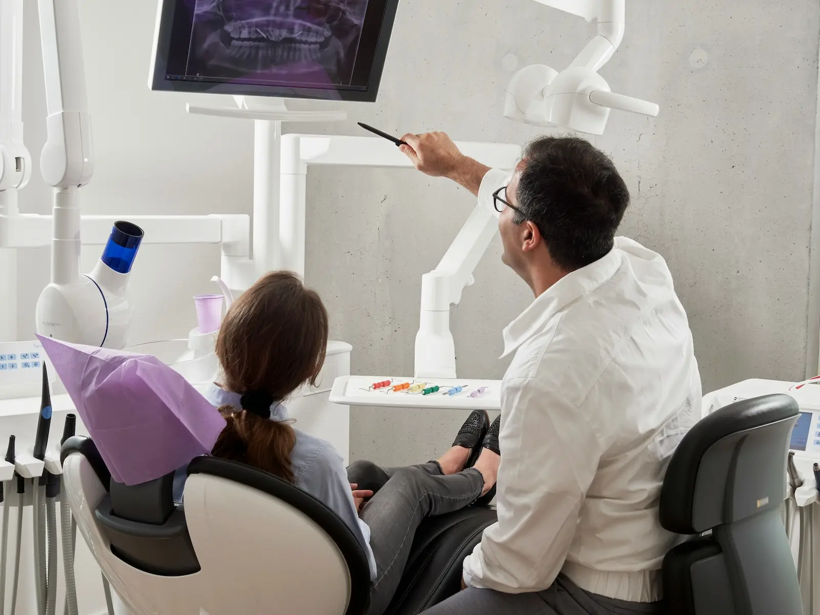 Dentist speaking with a patient in a modern clinic